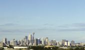 Qantas plane taking off from Sydney airport, with views to the city in the background