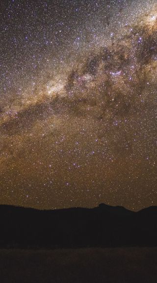 The starry Milky Way above the volcanic silhouette, Warrumbungles