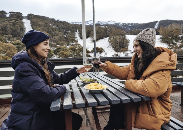 Thredbo, Snowy Mountains Women enjoying food and drink at The Local Pub in Thredbo Village, Snowy Mountains.