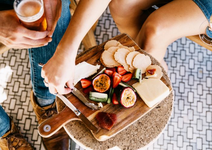 Couple enjoying cheeseboard at Blacksmith Provedore, Mulwala