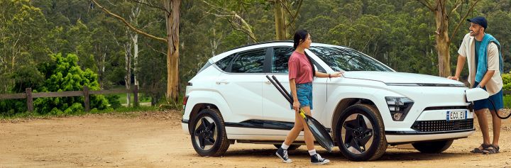 Couple charging EV for a road trip