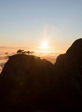 Hiker enjoying a scenic sun set at Kosciuszko National Park, Kosciuszko