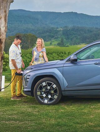 Couple charging EV for a road trip