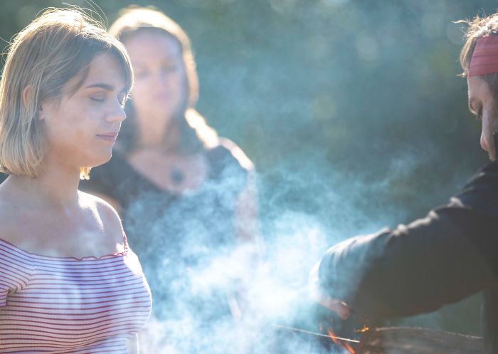 Yuin Retreat by Ngaran Ngaran Culture Awareness, Sapphire Coast - Credit: Yuin Retreat Woman experiencing smoking ceremony at Yuin Retreat by Ngaran Ngaran Culture Awareness, Sapphire Coast